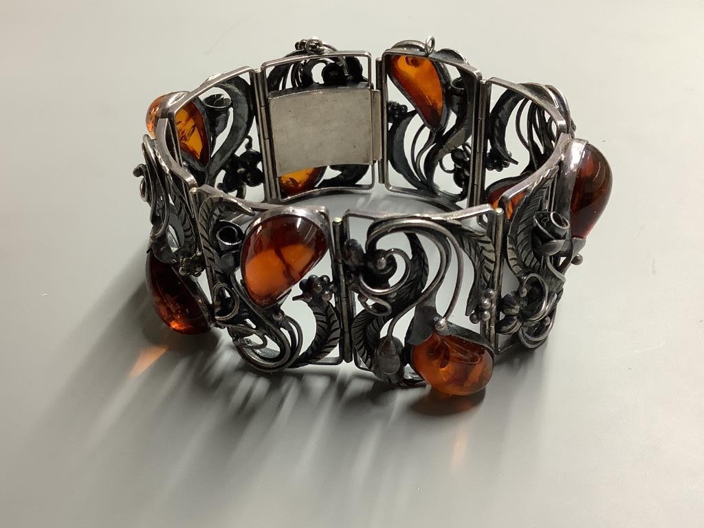 A 925 white metal and amber bracelet of foliate design, gross 56 grams.